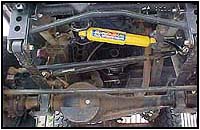 Installed on the dropped pitman arm above the knuckle-over steering system